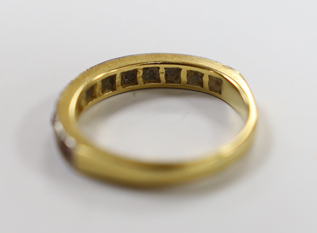 A 18ct and plat. six stone ruby and five stone diamond chip set half hoop ring, size L/M, gross weight 3.6 grams.
